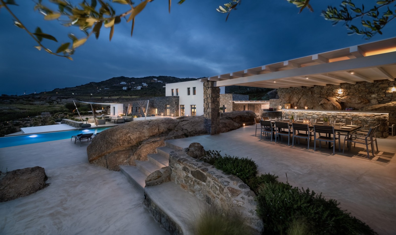 Luxury Mykonos villa terrace at evening with outdoor dining